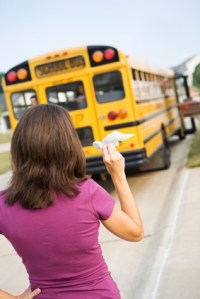 Mother waves goodbye to schoolbus