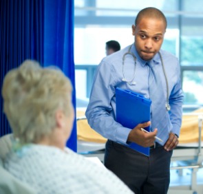 Doctor listening to patient in hospital