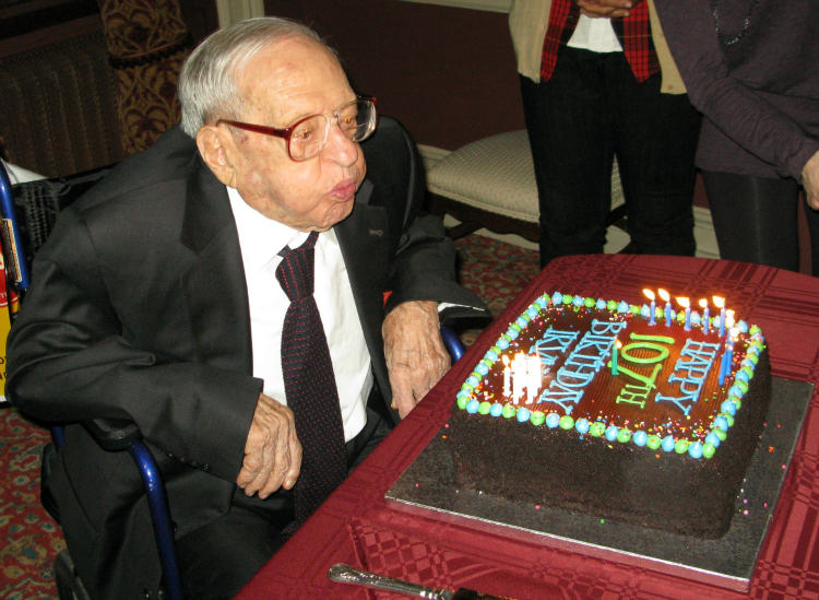 Irving Kahn blowing out the candles on his 107th birthday cake!