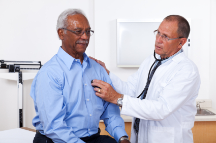 Doctor examines elderly man's heart
