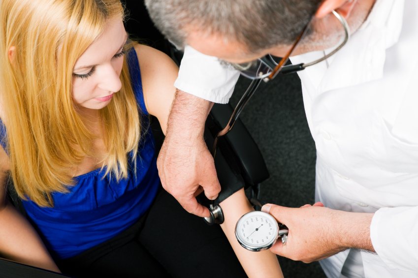 Young woman gets her blood pressure checked