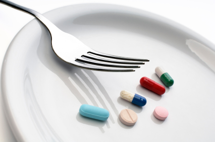 Multi-colored vitamins on a white plate