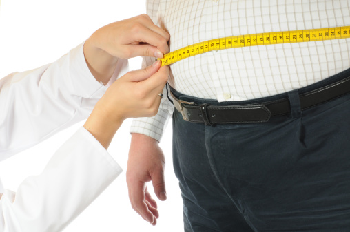 Tape measure being used on overweight male belly