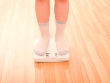 Feet of a boy standing on a scale