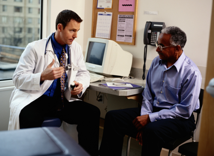 Doctor speaking with elderly male patient