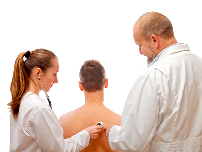 Student and doctor examine patient