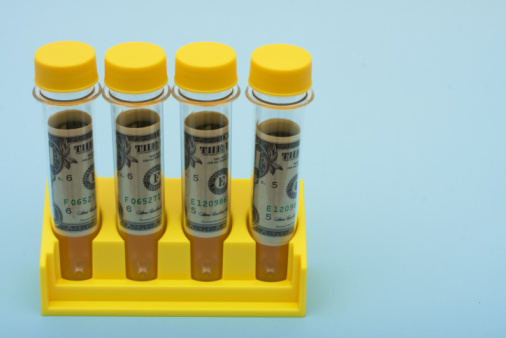 Rolled up dollars inside of test tubes