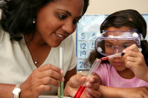 Student and teacher taking part in science lesson