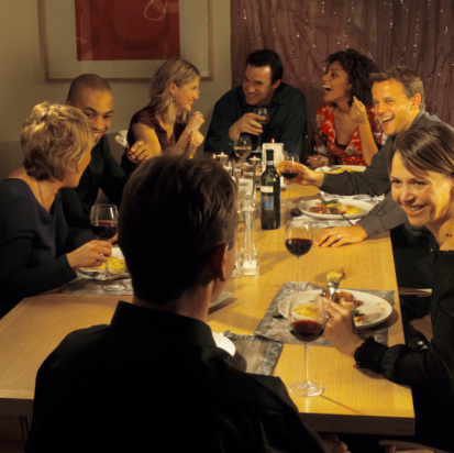 People seated at a table during a dinner party