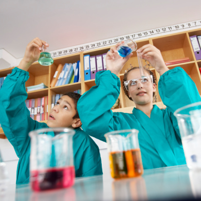 Children performing chemistry experiement