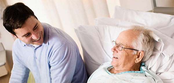 Young man visits older man in hospital