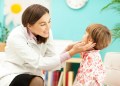 Pediatrician examines child