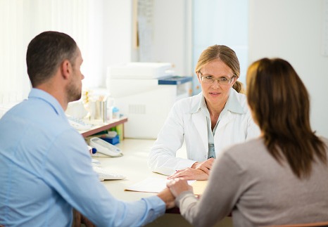 Couple receiving bad news from doctor