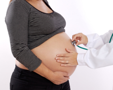 Pregnant woman examined by a doctor