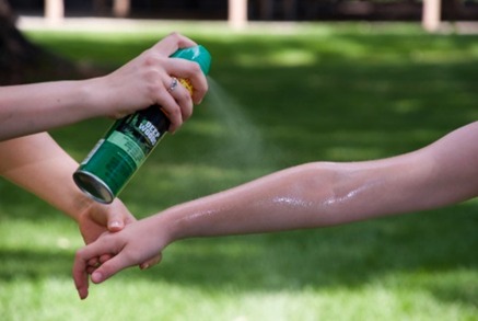 An arm being sprayed with mosquito repellant to prevent zika