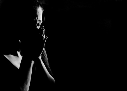 Black and white photo woman crying with hands over her mouth