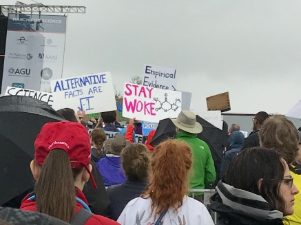 March for Science - Sign reading "Stay Woke"  [C8H10N4O2] 