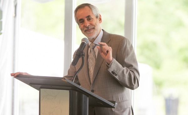Dr. Andrew Racine speaking at a  joint Masters Degree ceremony for Einstein's Clinical Research Training Program and the Einstein-Cardozo Master of Bioethics program at Einstein 