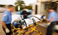 EMS workers lift patient into ambulance - intentionally fuzzy image