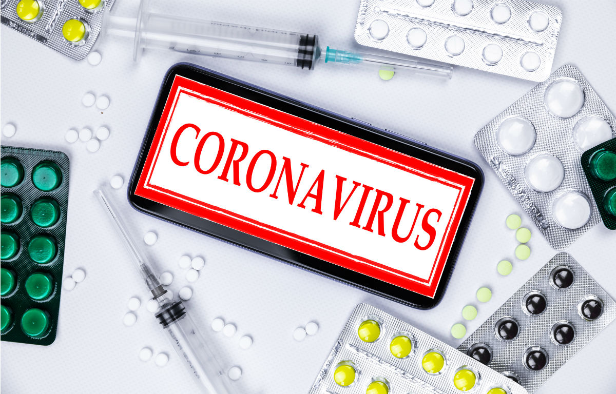Coronavirus sign surrounded by pills and needles